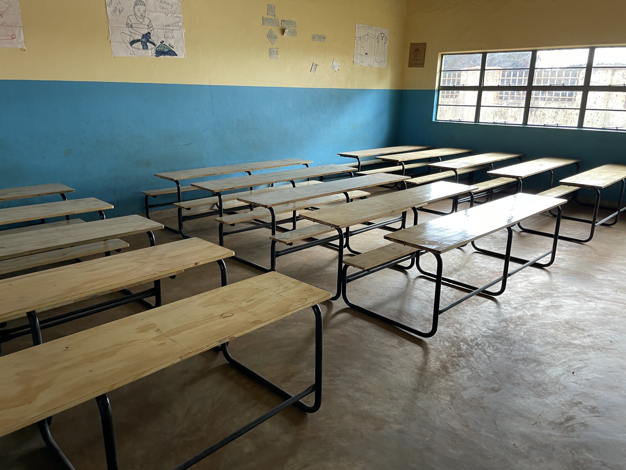 New desks inside classroom at Refugee Camp